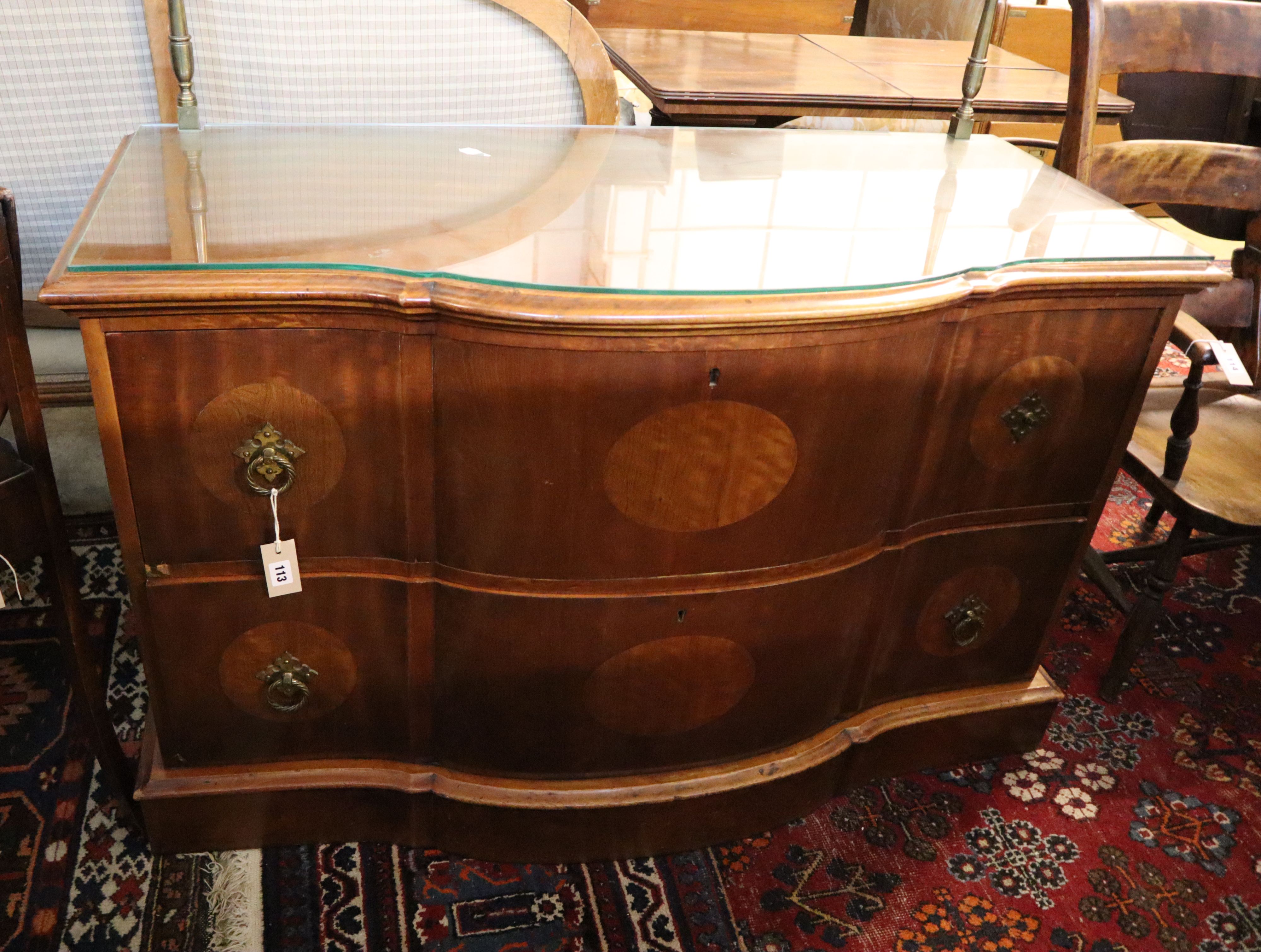 An inlaid walnut chest of shaped form, fitted two long drawers on plinth base, width 124cm, depth 58cm, height 78cm